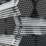 Stack of steel pipes in warehouse. Rolled metal products. 3d illustration.